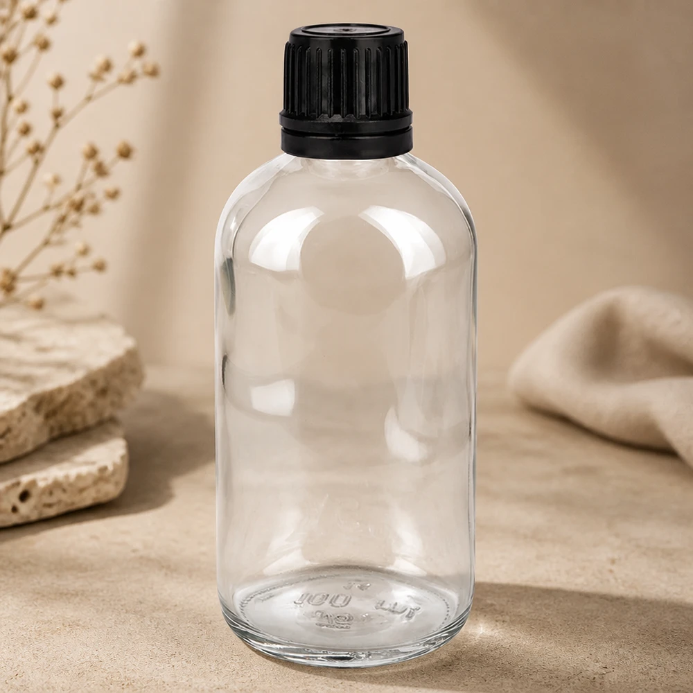 100 ml (kugle)Flas. 3mm GR s. STD ClearL. UT18/100 Apotekerflaske, 100 ml, klart glas med børnesikret skruelåg i sort