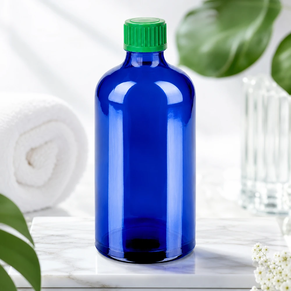 BlueLine-dråbeflaske 100 ml af høj kvalitet lavet af mørkeblåt glas med grønt skruelåg til UV-beskyttelse