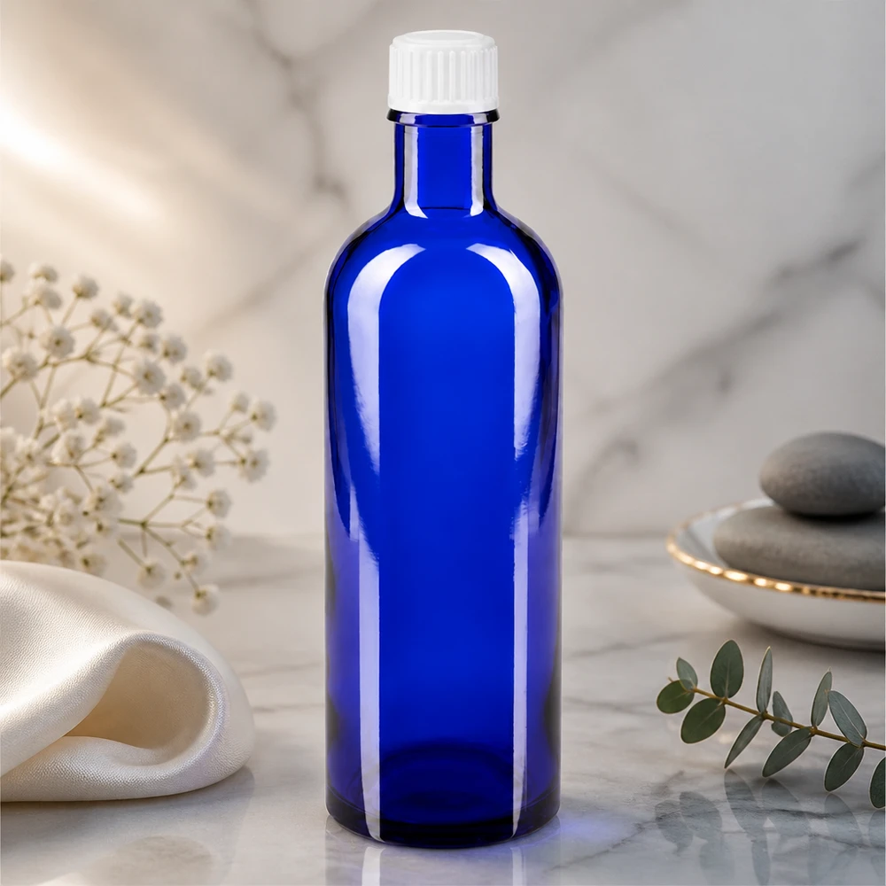 Apoteksflaske blå 200 ml skruelåg hvid pc Cylindrisk apotekerflaske på 200 ml i koboltblå med hvid plastskruelåg