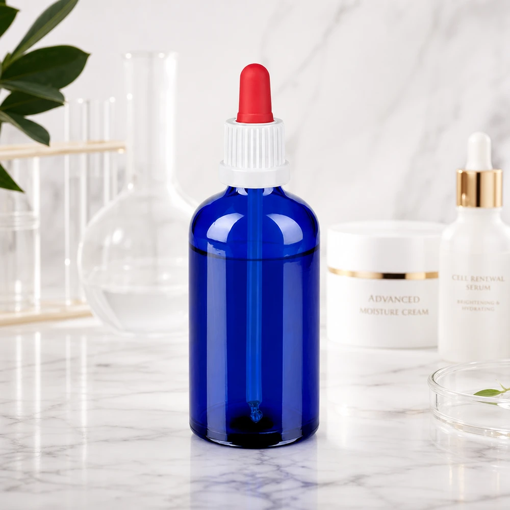 Kompakt 100 ml dråbeflaske af robust blåt glas til sikker opbevaring af væsker