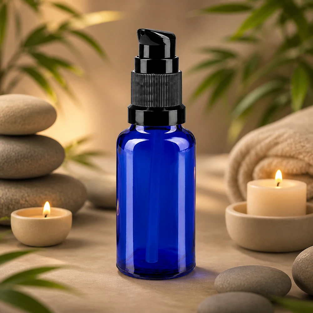 Apoteksflaske blå 20ml pumpehætte sort St Blå 20 ml pumpeflaske af apotekerglas med sort pumpehoved ved siden af massagesten og stearinlys