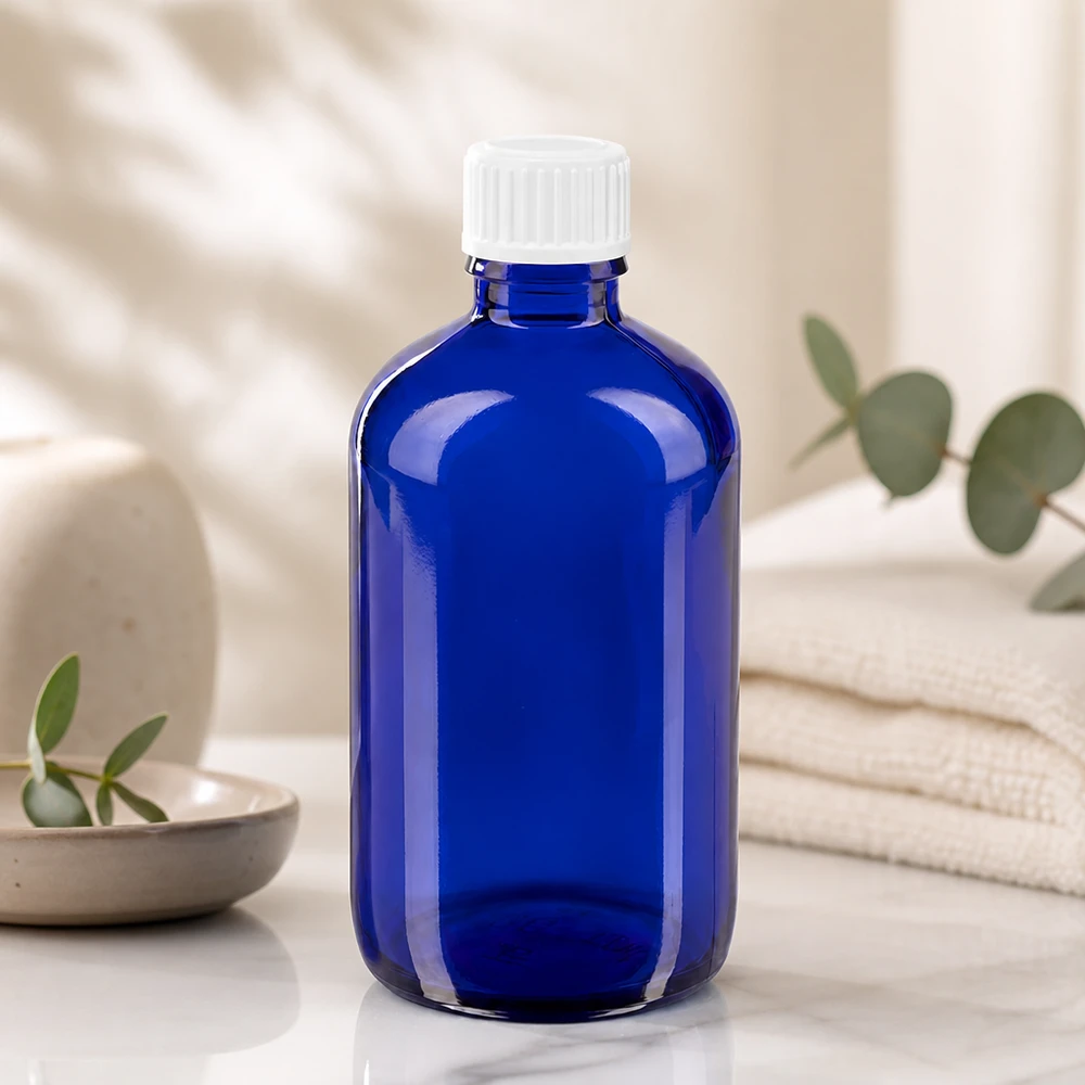 Koboltblå 100 ml dråbeflaske med børnesikret skruelåg af hvid plast
