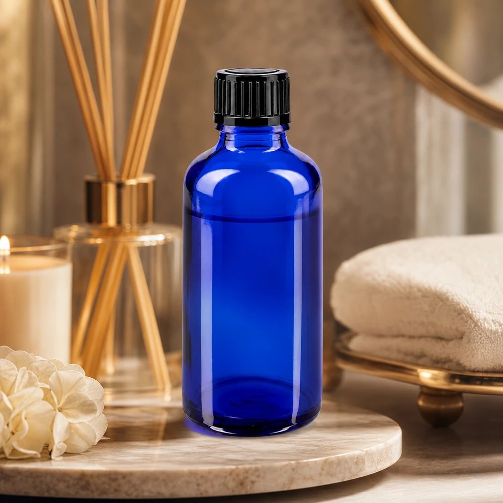 Koboltblå 50 ml dråbeflaske af apotekerglas med sort skruelåg i spa-stil