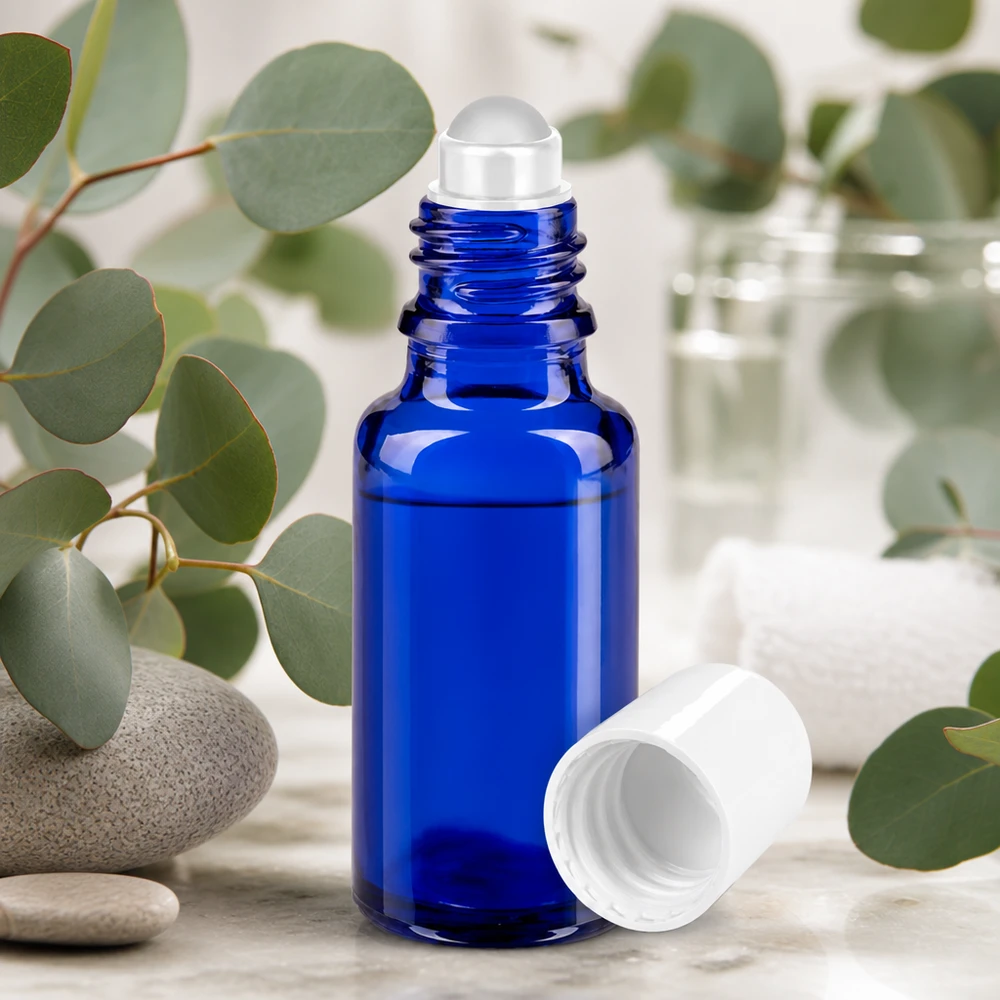 Apoteksflaske blå 20 ml roll-on-hætte hvid Blå 20 ml roll-on-flaske af apotekerglas med eukalyptusgrene og natursten