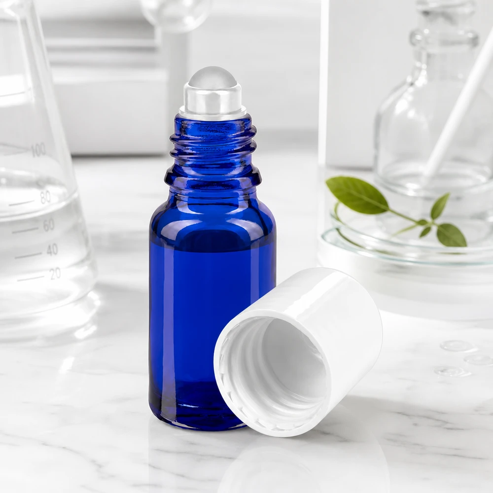 Apoteksflaske blå 10 ml roll-on-hætte hvid Koboltblå 10 ml roll-on-flaske med gennemsigtig glaskugle og hvidt låg på marmorbaggrund