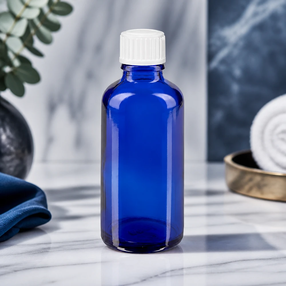 Apoteksflaske blå 50ml dråbetæller hvid 0,8mm stk. Koboltblå 50 ml STD-dråbeflaske af ApoGlas med hvid prop på marmoreffekt