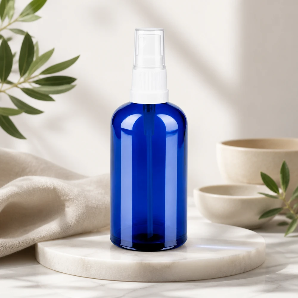 100 ml sprayflaske af høj kvalitet lavet af blåt glas med gennemsigtigt design til naturlig pleje