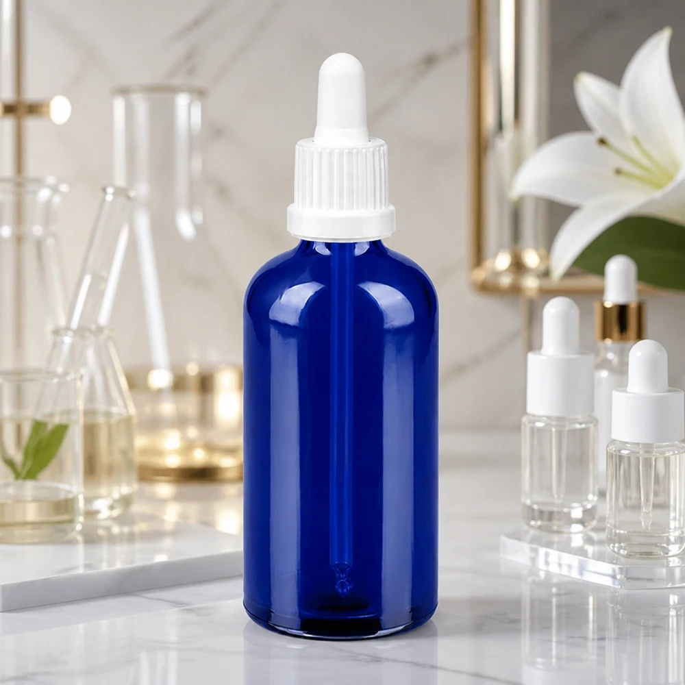 Elegant 100 ml glasflaske i blå med hvid pipette til stilfuld produktpræsentation BlueLine